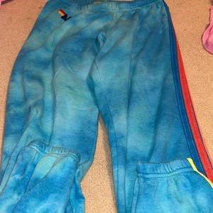 Aviator Nation tie dye blue sweatpants with neon 5 stripes on leg side
